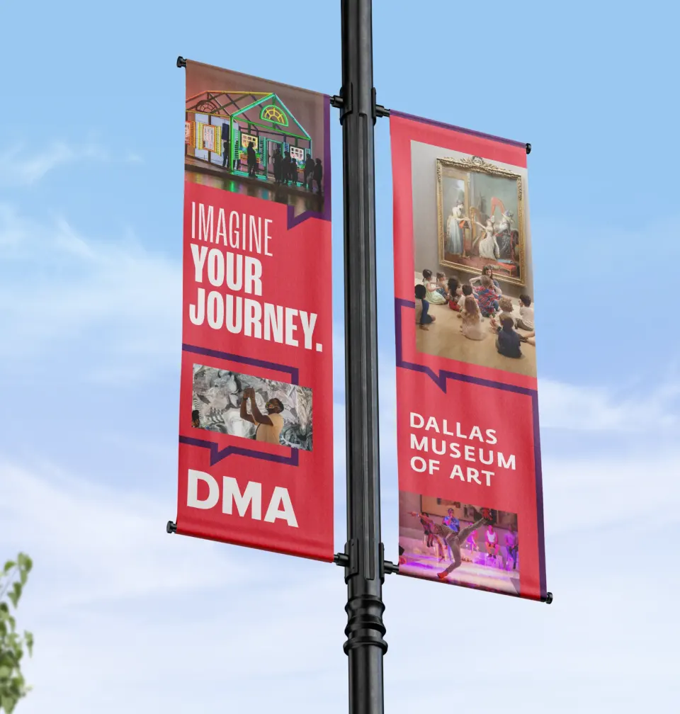 Street pole banners reading Imagine Your Journey, in DMA red
